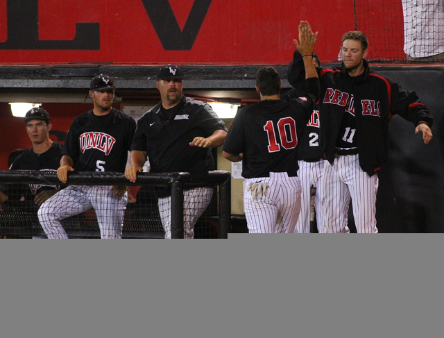 UNLV's T.J. White (10) reaches to high five Bryan Bonnell (11) after scoring a run in the first inning during a game in the Mountain West baseball tournament at Earl E. Wilson Stadium in Las Vegas ...
