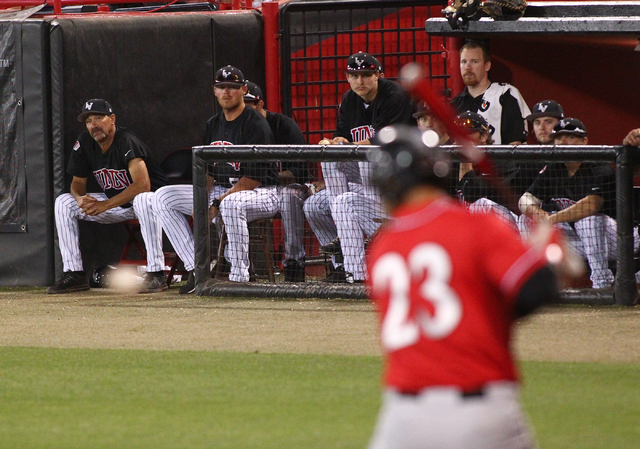 UNLV players and staff, including head coach Tim Chambers on far left, watch as San Diego State's Brad Haynal receives a pitch from UNLV during a game in the Mountain West baseball tournament at E ...