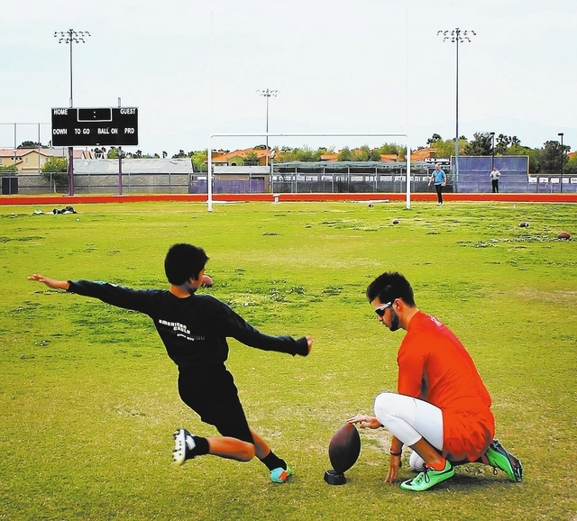 12-year-old Dillon Fedor practices his field goal kicking technique with his mentor, UNLV varsity kicker Nolan Kohorst, at Durango High School in Las Vegas on Friday, April 25, 2014. (Austin Conne ...