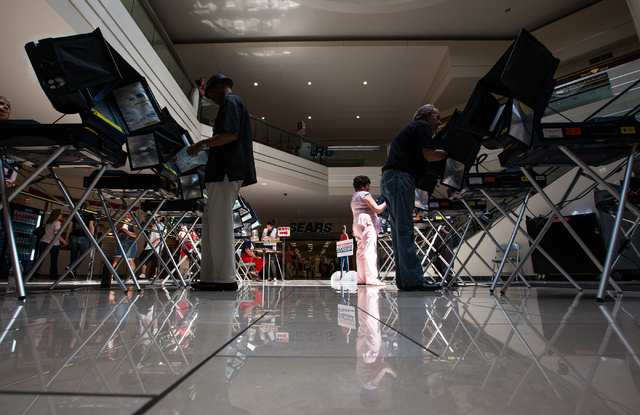 Pat Lawrence, center right, of Las Vegas, casts her ballot on the first day of early voting at the Meadows Mall in Las Vegas on Saturday, May 24, 2014. (Chase Stevens/Las Vegas Review-Journal)