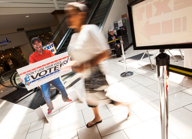 A woman exits the voting area after casting her ballot on the first day of early voting at the Meadows Mall in Las Vegas on Saturday, May 24, 2014. (Chase Stevens/Las Vegas Review-Journal)