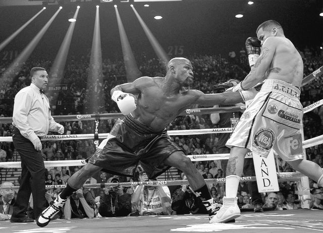 Floyd Mayweather Jr. hits Marcos Maidana during their welterweight title bout at the MGM Grand in Las Vegas Saturday, May 3, 2014. (Jason Bean/Las Vegas Review-Journal)