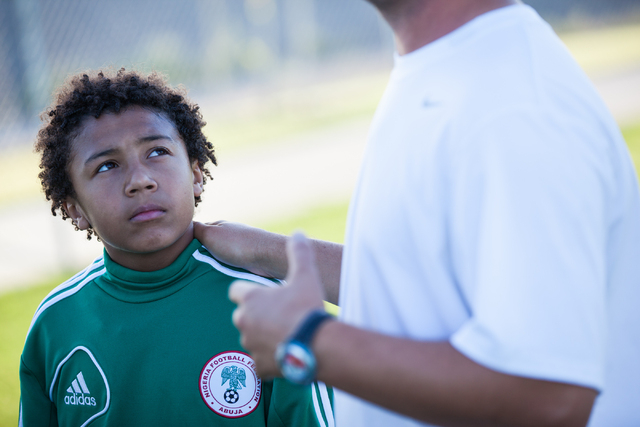 Ten-year-old Lateef Omidiji Jr., left, listens as his coach, Esad Morina, speaks with the Review-Journal before Omidiji Jr.'s soccer practice at Russell Road Recreation Complex, 5901 E. Russell Rd ...