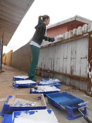 Christine Rabah paints a fence April 26 at the home of Gary Meador. She was part of the team volunteering with Rebuilding Together Southern Nevada. (Jan Hogan/View)