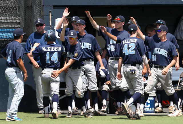 Centennial's Josh McKibin is greeted by teammates after he scored in the third inning to tie the game at 1-1. Liberty defeated the Bulldogs 5-3 to win the Division I state title. (Cathleen Allison ...