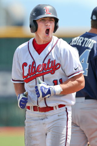 Liberty's Preston Pavlica yells to the dugout after hitting one of his two RBI triples against Centennial on Saturday during the Division I state championship game. Liberty defeated Centennial 5-3 ...