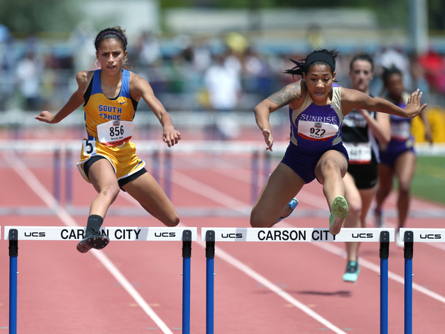 Sunrise Mountain's Brittany Veal, right, wins the Division I-A girls 300-meter hurdles with a time of 44.55 seconds, just ahead of South Lake Tahoe's Maya Brosch at 44.59. (Cathleen Allison/Specia ...