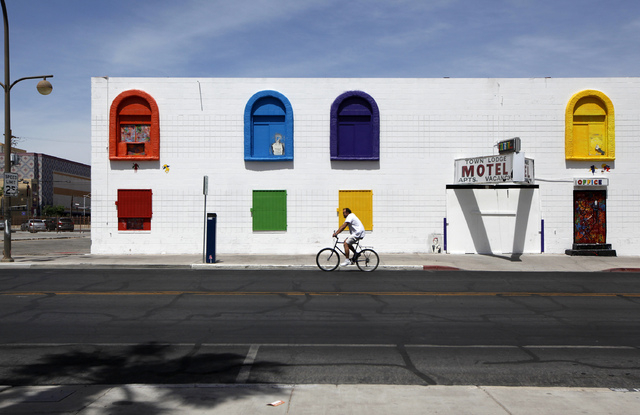 A man cycles past the closed Town Lodge Motel on 7th Street in downtown Las Vegas on Sunday, May 18, 2014. After record high heat on Saturday, the temperature cool off on Sunday. Expect more coole ...