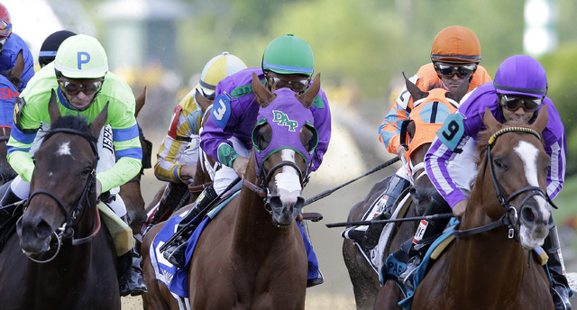 California Chrome, center, ridden by Victor Espinoza in Preakness Stakes, tries to win the Belmont Stakes on Saturday and complete the Triple Crown. (AP Photo/Patrick Semansky)