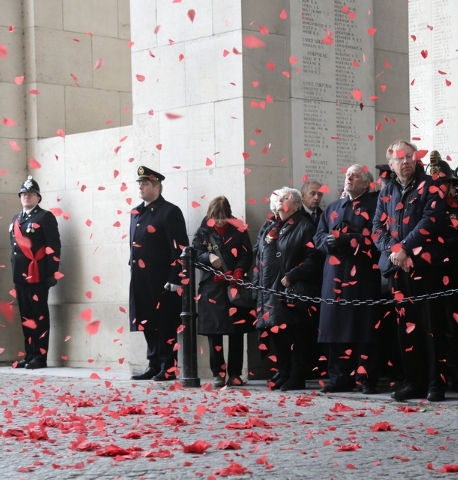 In this Monday, Nov. 11, 2013 file photo, visitors look up at paper poppies as they fall from the ceiling during an Armistice Day ceremony under the Menin Gate in Ypres, Belgium. The Menin Gate Me ...