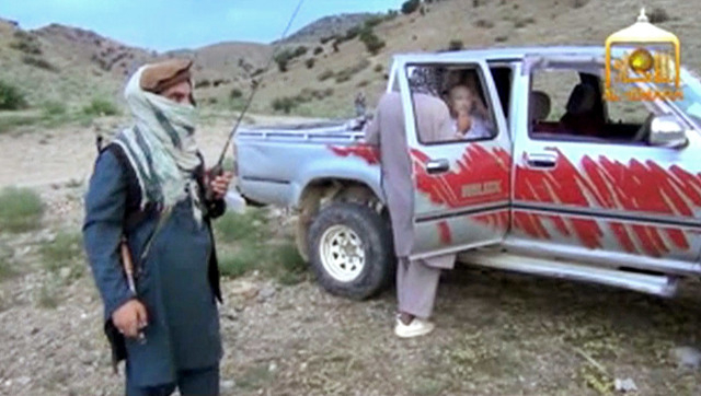 In this image taken from video obtained from Voice Of Jihad Website, Sgt. Bowe Bergdahl sits in a vehicle guarded by the Taliban in eastern Afghanistan. The Taliban have released a video showing t ...