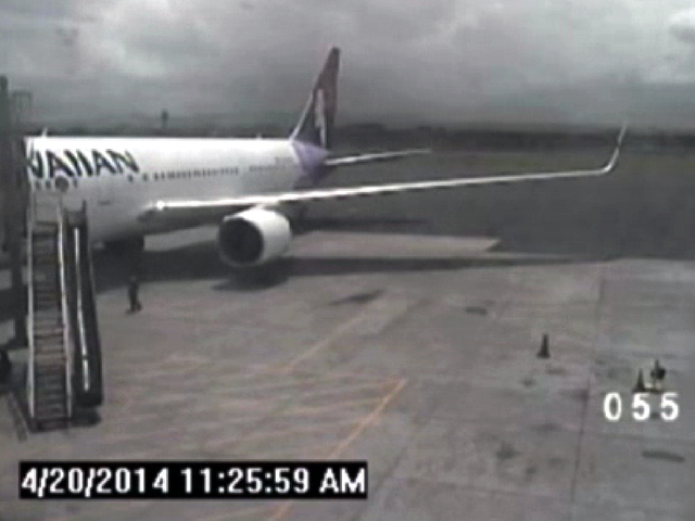 This file image taken from a surveillance video shows a California teen, left, after hopping from a jet's wheel well in Maui, Hawaii, on April 20, 2014. When it was time for that same jet to leave ...