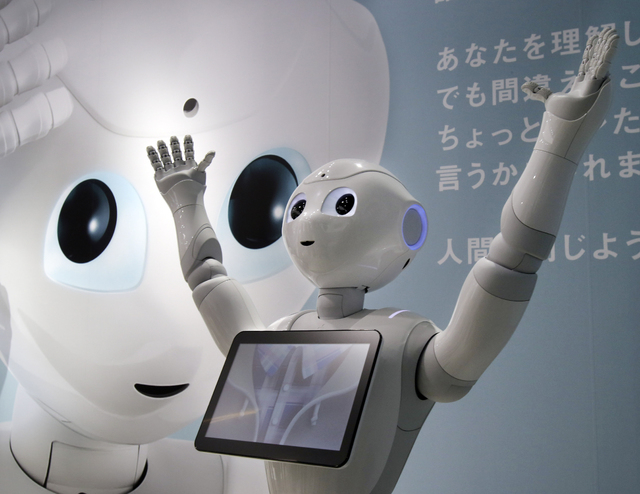 Humanoid Robot "Pepper" is displayed at SoftBank Mobile shop in Tokyo, Friday, June 6, 2014. Pepper, which has no hair but two large doll-like eyes and a flat-panel display stuck on its chest, was ...