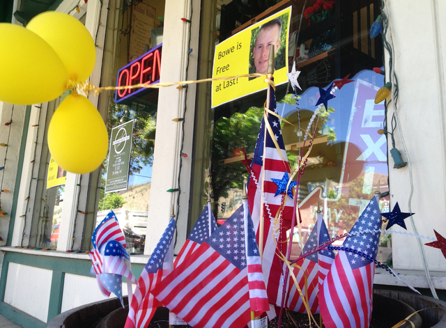This June 4, 2014 file photo shows flags and balloons marking the release from captivity of Sgt. Bowe Bergdahl adorn the sidewalk outside a shop in the soldier's hometown of Hailey, Idaho. That fe ...
