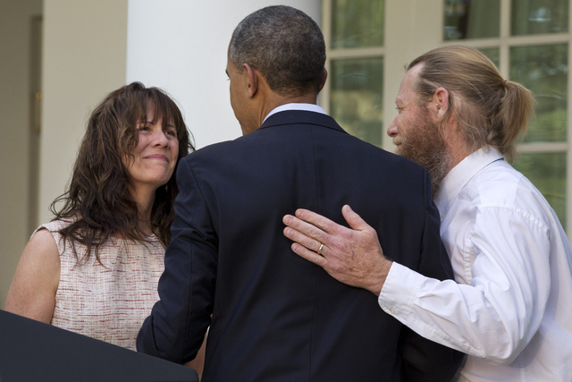 This May 31, 2014 file photo shows the parents of U.S. Army Sgt. Bowe Bergdahl, Jani Bergdahl, left, and Bob Bergdahl, turn to President Barack Obama after he spoke in the Rose Garden of the White ...