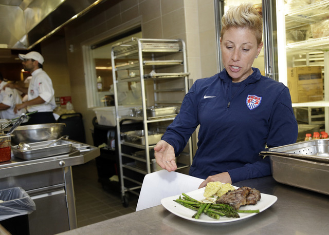 In this photo taken May 21, 2014, U.S. soccer sports performance dietitian Danielle LaFata talks in Stanford, Calif., about the team's food menu as the team trains in preparation for the World Cup ...