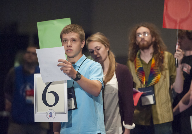 Young Adult Advisor Scott Overacker, of Roanoke, VA., front, adds his voice to the debate on whether the church should recognize same-sex marriage at the  221st General Assembly of the Presbyteria ...