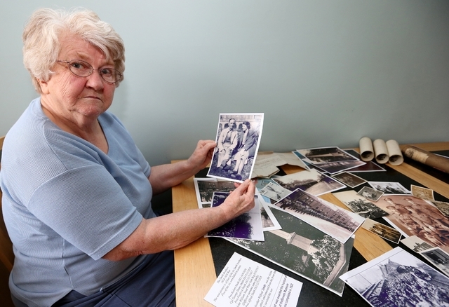 In this May 7, 2014, Dianne Nelson, 70, the daughter of World War I Pvt. Wilfred Smith, shows family photos during an interview at her home in Barnard Castle, England. Nelson said that her father ...