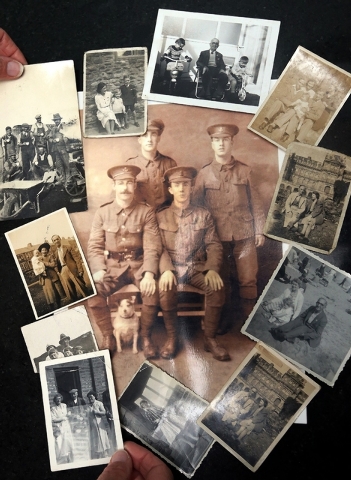 In this May 7, 2014 photo, Amanda Nelson, the granddaughter of World War I Pvt. Wilfred Smith, shows family photographs during an interview at her home in Barnard Castle, England. Nelson said that ...