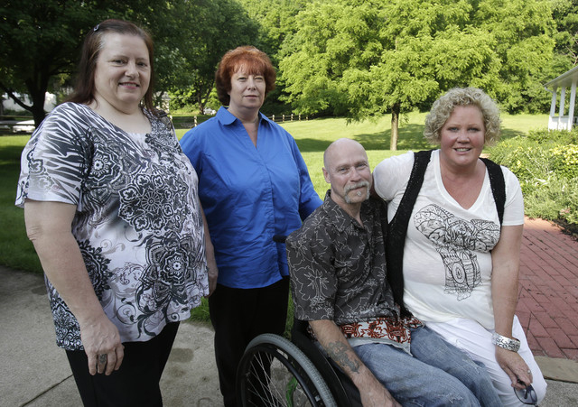 This Monday, June 16, 2014 photo shows Diane Conrad, left to right, Cyndy Stapleton, Bill Palmisano, and Melinda Elkins Dawson posing for a portrait in North Canton, Ohio. A northern Georgia docto ...