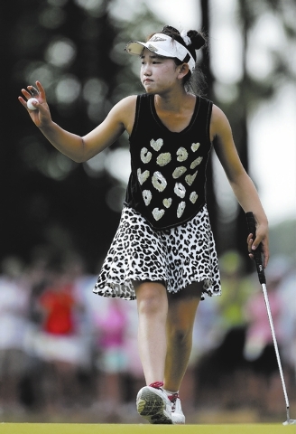Lucy Li, 11, acknowledges fans after making a putt on the 13th hole during the second round of the U.S. Women’s Open on Friday at Pinehurt No. 2 in Pinehurst, N.C. (AP Photo/Bob Leverone)
