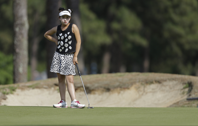 Lucy Li waits to putt on the 14th hole during the second round of the U.S. Women's Open golf tournament in Pinehurst, N.C., Friday, June 20, 2014. (AP Photo/Bob Leverone)