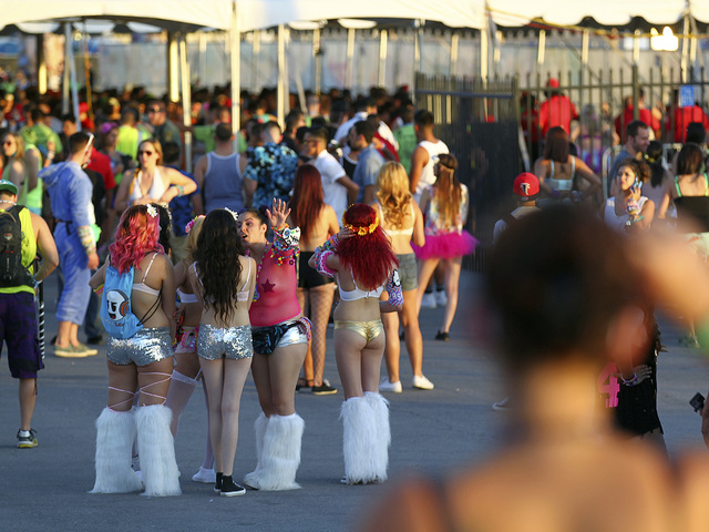 Attendees wait near an entrance as people arrive at the Electric Daisy Carnival at the Las Vegas Motor Speedway in Las Vegas on Friday, June 20, 2014. (Chase Stevens/Las Vegas Review-Journal)