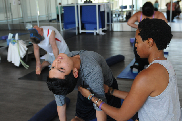 Yoga instructor Chidimma Ozor helps Mark Esperanza, 17, with a stretching pose during a June 9 class at Turntable Health, 701 Bridger Ave., Suite 150. (Erik Verduzco/View)