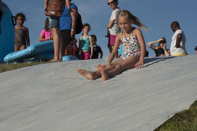Children participate in the 2013 Slide into Summer event sponsored by the city of Henderson. This year's even is slated to feature games and activities including giant lawn-top water slides from 5 ...