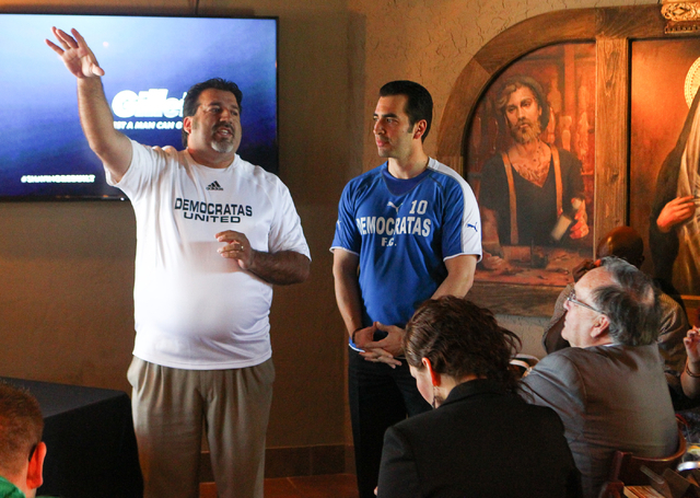 Andres Ramirez, left, speaks as State Sen. Ruben Kihuen, D-Las Vegas, looks on during Kihuen's "Soccer with the Senator" event for supporters featuring a watch party for the Mexico vs. B ...