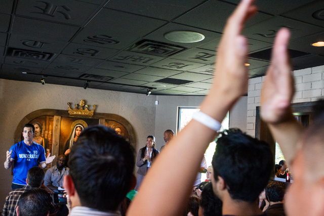 State Sen. Ruben Kihuen, D-Las Vegas, bottom eft, speaks during his "Soccer with the Senator" event for supporters featuring a watch party for the Mexico vs. Brazil World Cup game at Tac ...