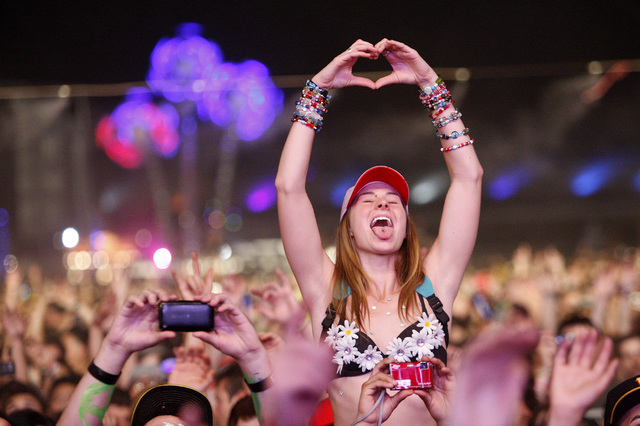 An attendee makes a heart sign while in the crowd during a set at the Electric Daisy Carnival at the Las Vegas Motor Speedway on Monday, June 27, 2011. (John Locher/Las Vegas Review-Journal)