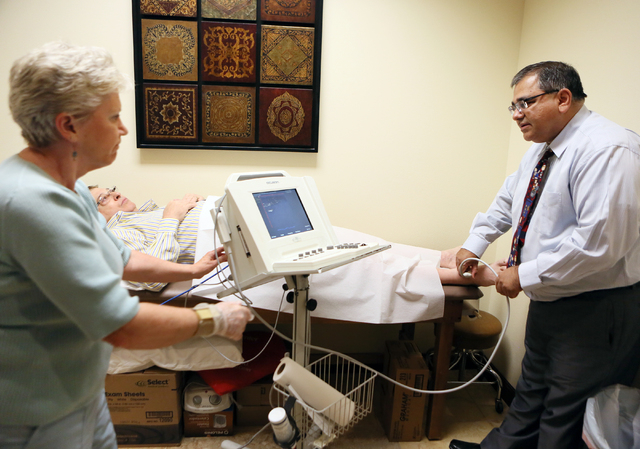 Dr. Kenneth Shah, right, demonstrates an ultrasound on patient Rick Carter, 69, center, at Vascular Institute of Southern Nevada Tuesday, May 13, 2014, in Henderson. Cardiovascular Ultrasound Tech ...
