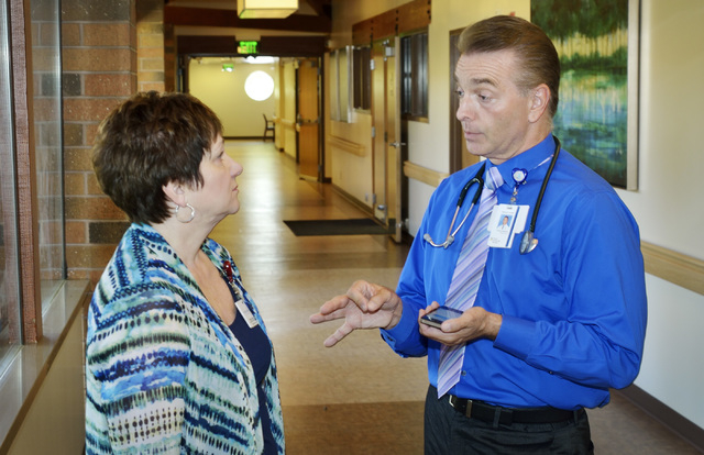 Dr. Michael Karagiozis, medical director for Nathan Adelson Hospice, right, talks with nurse Pamela Cate at the hospice at 4131 Swenson St. in Las Vegas on Friday, June 6, 2014. (Bill Hughes/Las V ...