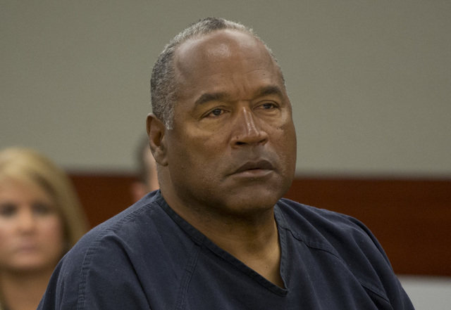 O.J. Simpson listens to audio recording played during an evidentiary hearing in Clark County District Court, Thursday, May 16, 2013 in Las Vegas. Simpson, who is currently serving a nine to 33-yea ...