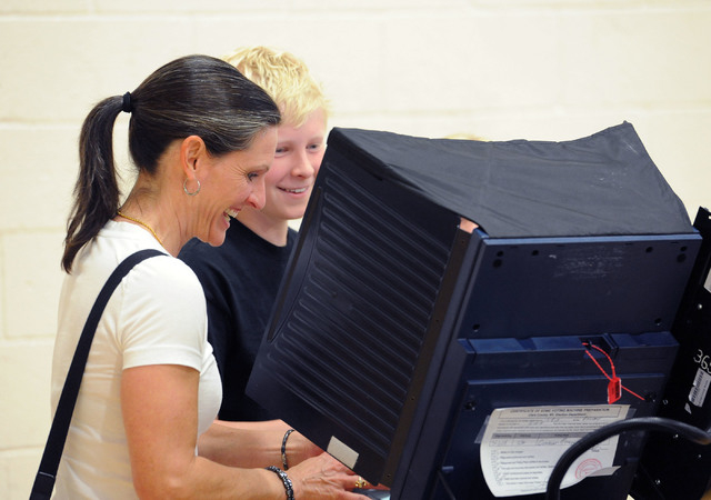 Darcy Bechtel laughs as she votes while showing her son, Jack, 12, the process at Cimarron-Memorial High School in Las Vegas, Tuesday, June 10, 2014. (Jerry Henkel/Las Vegas Review-Journal)
