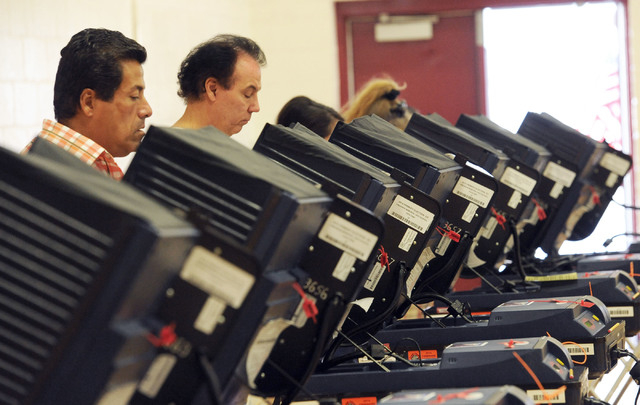 Tony Guerrero, left, works on his ballot as he and others vote at Cimarron-Memorial High School in Las Vegas, Tuesday, June 10, 2014. (Jerry Henkel/Las Vegas Review-Journal)