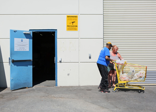 Billy King, left, helps Victoria Murphy with her bags of groceries at the Lutheran Social Services of Nevada's food pantry Friday, May 30, 2014, in Las Vegas. The Lutheran Social Services of Nevad ...