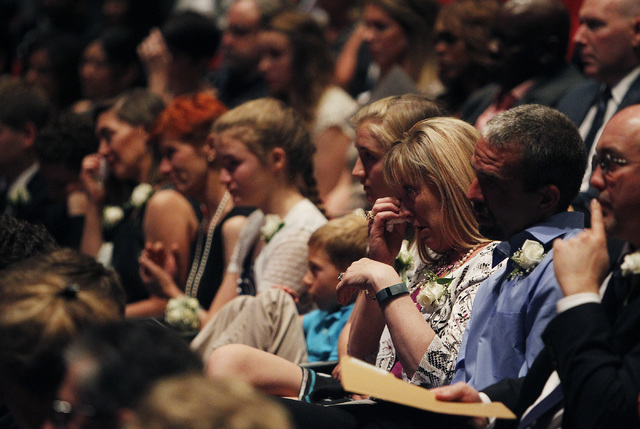 Kimberley Rogers, daughter of Jim Rogers, third from right, reacts to a speaker during the memorial service for her father, the late Jim Rogers, at Ham Concert Hall at UNLV in Las Vegas on Saturda ...