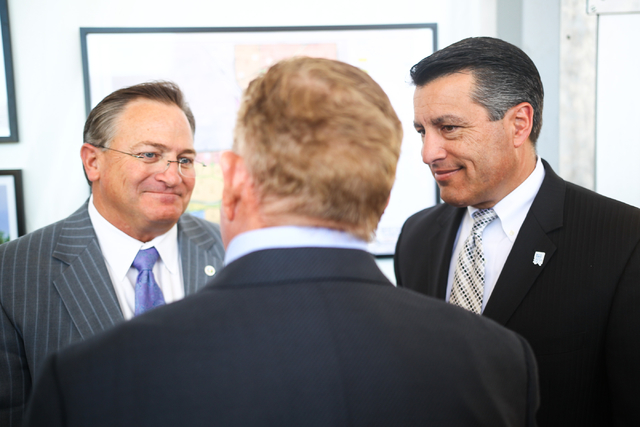 Gov. Brian Sandoval, right, and Las Vegas City Councilman Steve Ross , left, listen to Garry Goett, CEO and chairman of Olympia Companies, which is the developer of the Skye Canyon master planned  ...