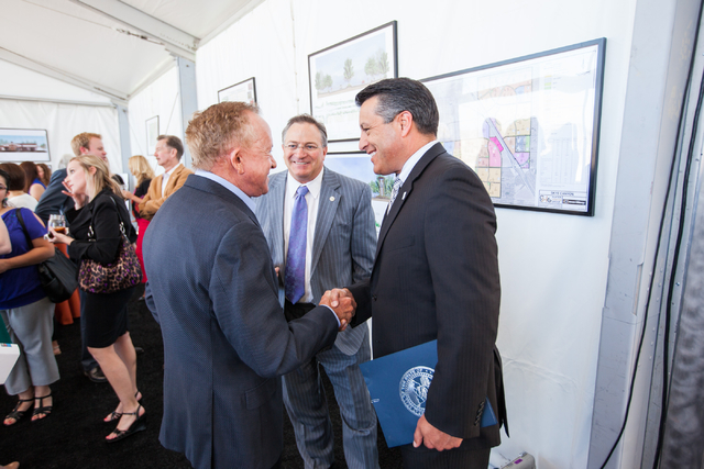 Gov. Brian Sandoval, right, shakes hands with Garry Goett, CEO and chairman of Olympia Companies, which is the developer of the Skye Canyon master planned community, during the groundbreaking cere ...