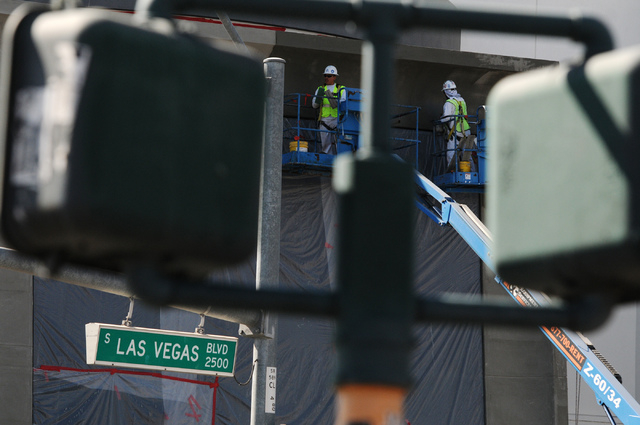 Workers resurface cement walls at the construction site of the new SLS Las Vegas casino-hotel at the intersection of Sahara Avenue and Las Vegas Boulevard in Las Vegas Wednesday, June 4, 2014. (Er ...