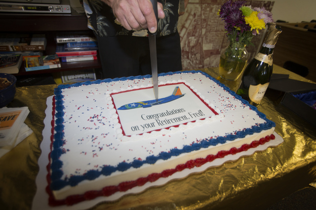 Southwest Airline  pilot Capt. Fred Sorenson cuts a cake in the pilots lounge a McCarran International Airport after making his final flight with the airlines  on Wednesday, June 11 , 2014.  Soren ...