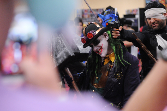 Rene Hernandez, right, in character as The Punisher, and Mike Syfritt, in character as Gaslight Joker, pose for photos during the 2014 Amazing Las Vegas Comic Con at South Point casino-hotel in La ...