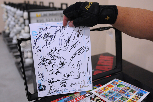 Mark Niven shows autographs he has collected from comic book artists during the 2014 Amazing Las Vegas Comic Con at South Point casino-hotel in Las Vegas Saturday, June 21, 2014. (Erik Verduzco/La ...