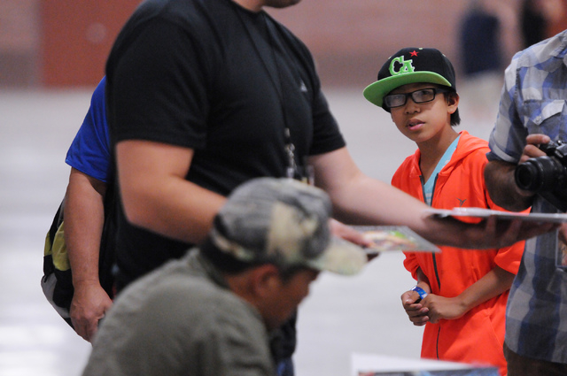 Christian McGonagle, 10, waits in line for an autograph from comic book illustrator and publisher Jim Lee during the 2014 Amazing Las Vegas Comic Con at South Point casino-hotel in Las Vegas Satur ...