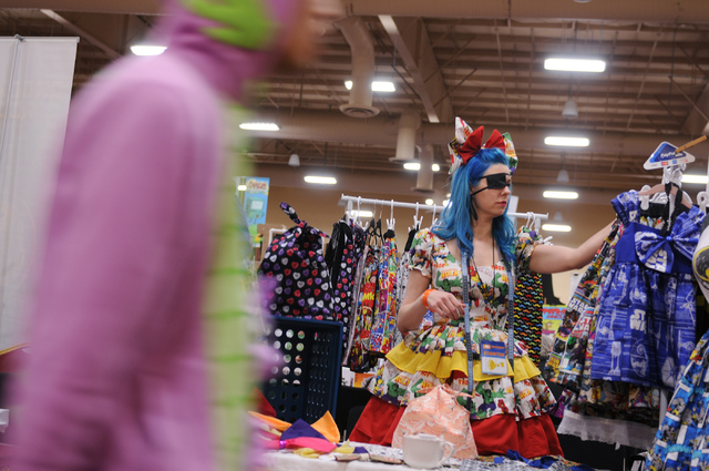 Kimberly Fisher, owner of Girl With One Eye dress shop, organizes merchandise as she waits for costumers during the 2014 Amazing Las Vegas Comic Con at South Point casino-hotel in Las Vegas Saturd ...