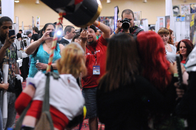 Attendees photograph people in costumes during the 2014 Amazing Las Vegas Comic Con at South Point casino-hotel in Las Vegas Saturday, June 21, 2014. (Erik Verduzco/Las Vegas Review-Journal)