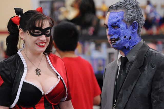 Ben Kimberlin, right, in character as Two-Face, and his wife Beth, in character as Harley Quinn, browse a comic book stand during the 2014 Amazing Las Vegas Comic Con at South Point casino-hotel i ...