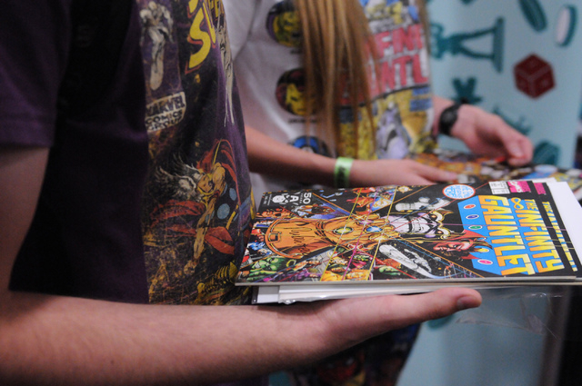 Michael Swanson, left, and his friend Amber Schaff, wait in line to get autographs from comic book illustrator George Perez during the 2014 Amazing Las Vegas Comic Con at South Point casino-hotel  ...